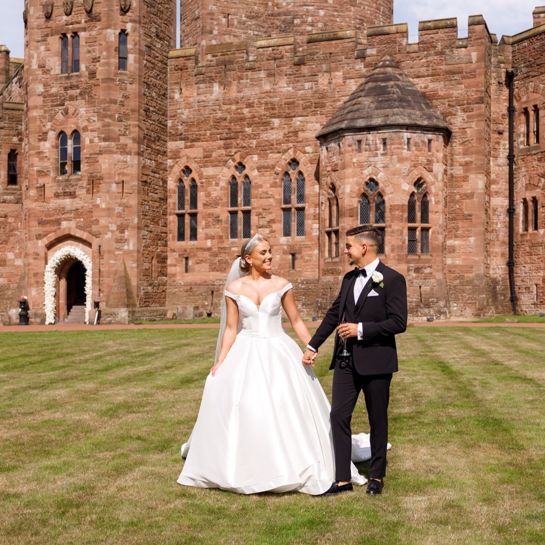 Bride and groom on castle grounds at Peckforton Castle, cheshire wedding venue