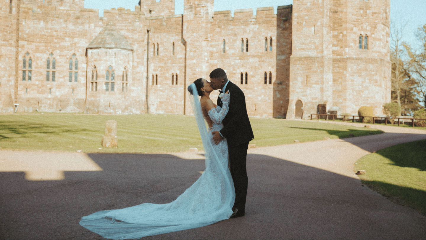 Couple kissing outside Peckforton Castle